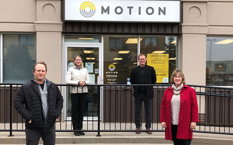 Group in front of Motion storefront.