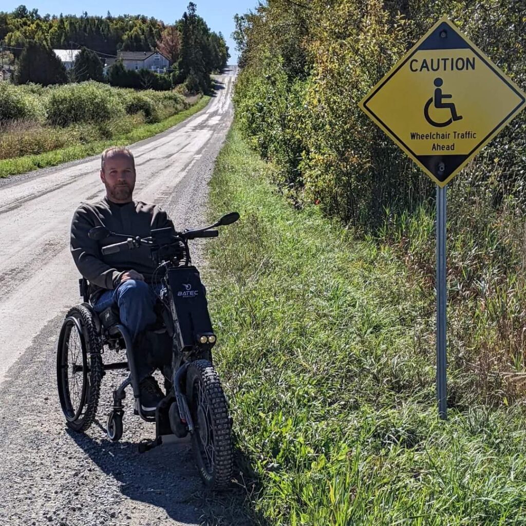 Man in wheelchair on road