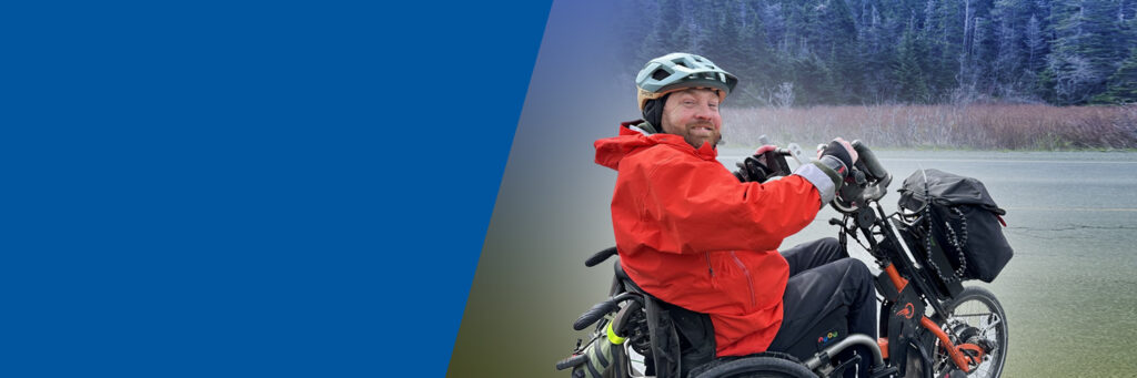 Kevin Mills on his hand cycle on the open road.