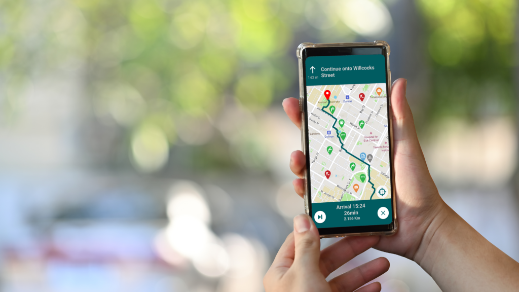 person holding mobile phone showing map app