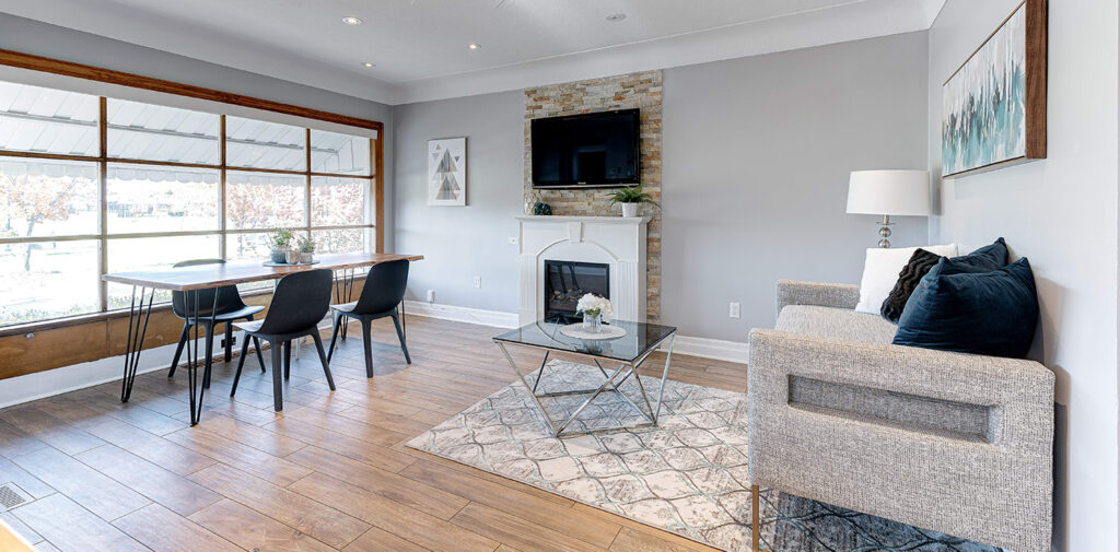 A bright and spacious accessible living room with an oak table and modern grey sofa.