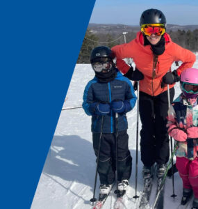 Antoine family on top of the slopes on a sunny ski day.