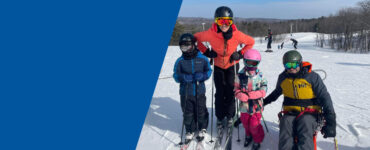 Antoine family on top of the slopes on a sunny ski day.