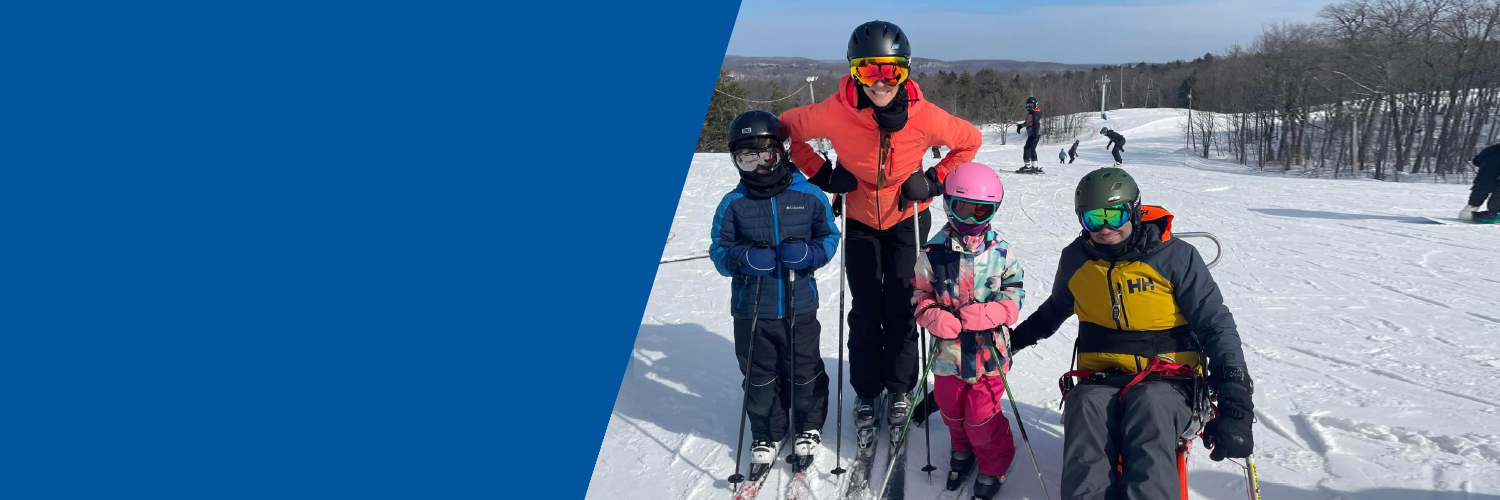 Antoine family on top of the slopes on a sunny ski day.