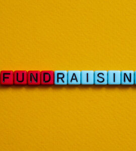 Letter beads that spell the word FUNDRAISING