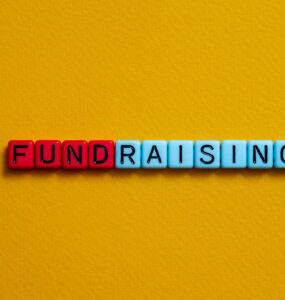 Letter beads that spell the word FUNDRAISING