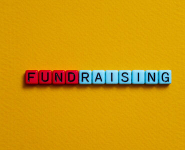 Letter beads that spell the word FUNDRAISING