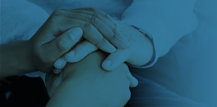 Close-up of hands giving support.