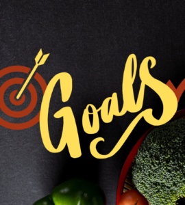 Image of heathy food and running shoes against a starck black background with the words, "Goals" written across the image.