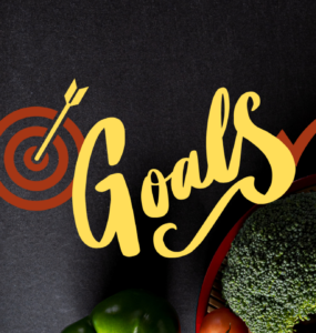 Image of heathy food and running shoes against a starck black background with the words, "Goals" written across the image.