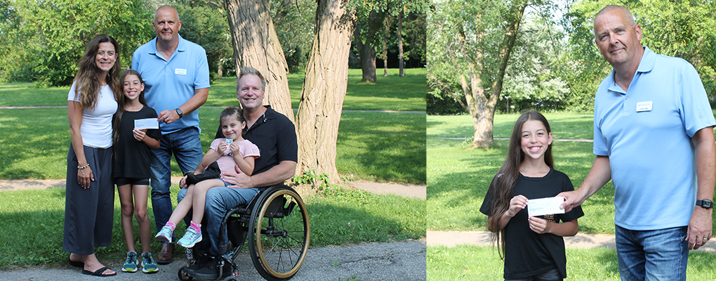 Young Julia and her family give their cheque donation to Executive Director, Stuart Howe