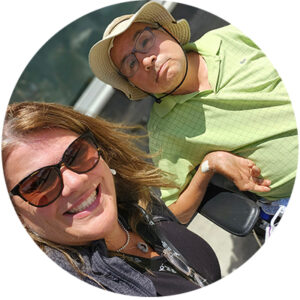 Matthew, who uses a wheelchair, and his sister outside in the sun.