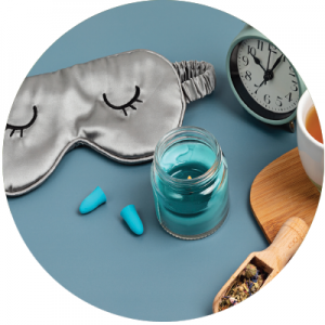 An assortment of sleep remedies including a mask, vitamins and a sleep clock.