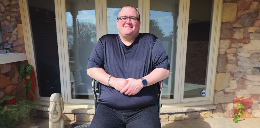 Steven Cedrone sitting in front of his home with the help of his walker.