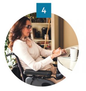 Woman in a wheelchair using her laptop for work.