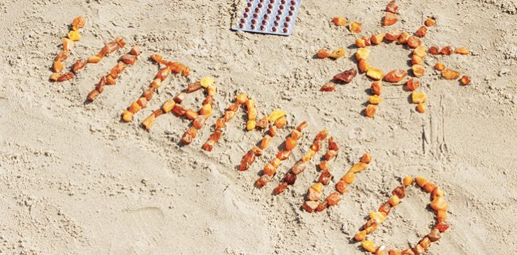 Words "Vitamin D" spelled out with vitamin capsules.