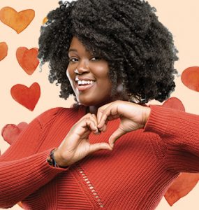 African American women making a heart symbol with her hands.