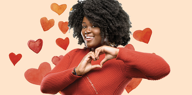 African American women making a heart symbol with her hands.